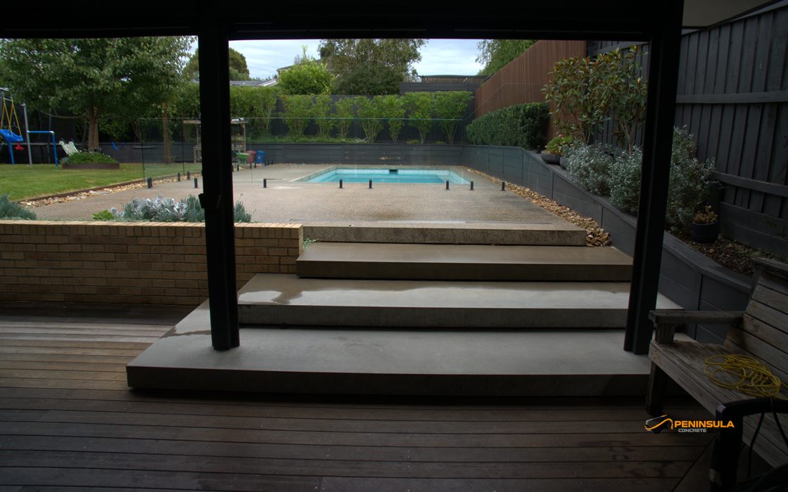 Covered steps leading to a sealed exposed aggregate pool surround on the Mornington Peninsula