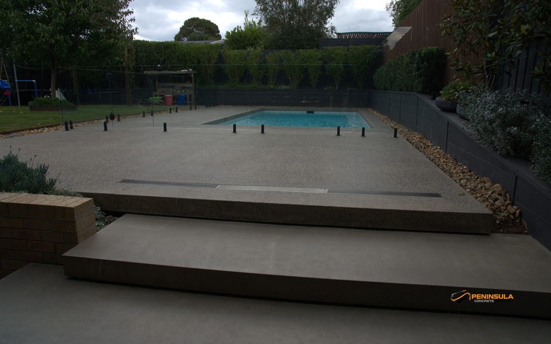 Sealed pool surrounds viewed from polished concrete steps