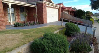 Nice garden around a freshly painted driveway