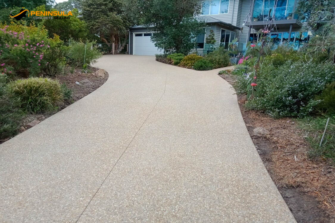 An exposed aggregate after driveway cleaning looking like new again